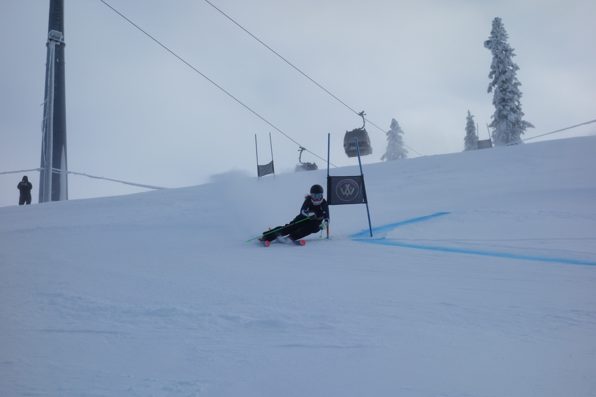 Peregrine female alpine ski racer carving a turn at sunrise